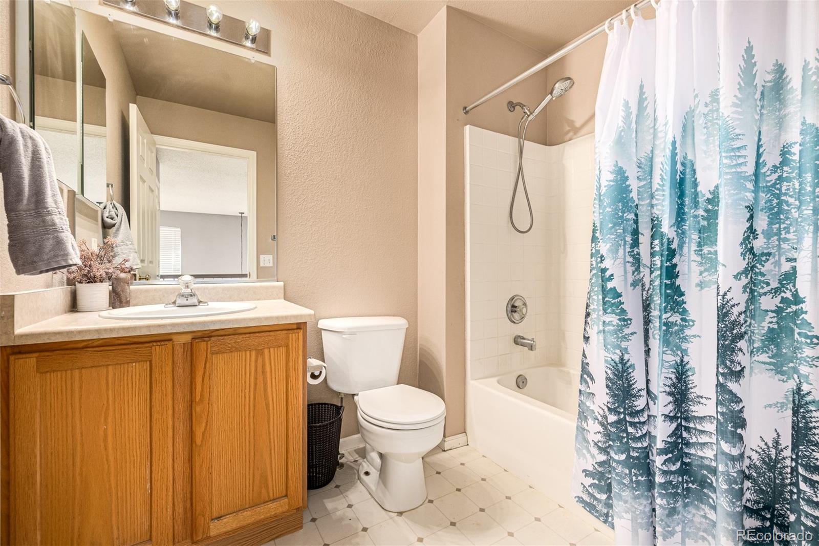 21300 East 42nd Avenue Denver, CO 80249 - Photo 30 of 48 a bathroom with a granite countertop sink toilet and shower