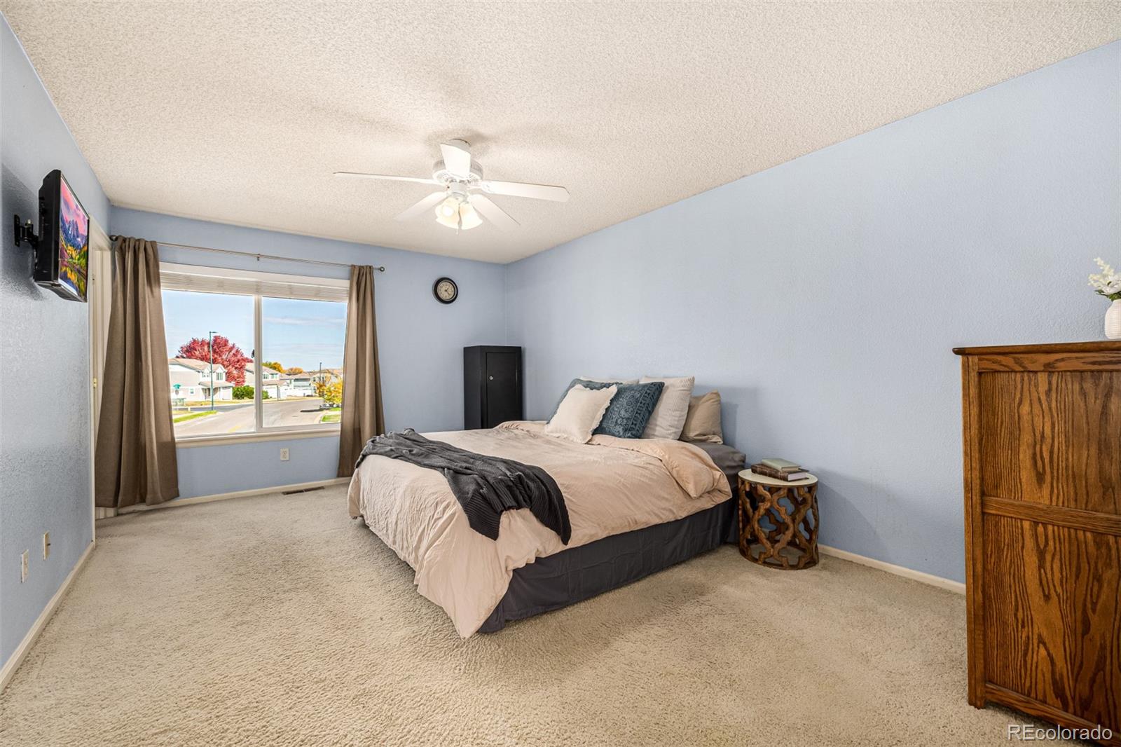 21300 East 42nd Avenue Denver, CO 80249 - Photo 33 of 48 a spacious bedroom with a bed and a chandelier