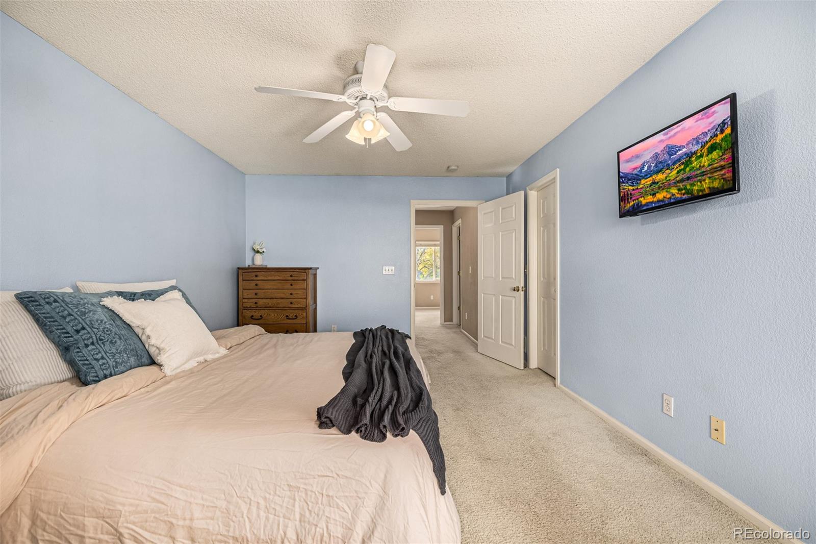 21300 East 42nd Avenue Denver, CO 80249 - Photo 34 of 48 a bedroom with a bed and painting on the wall