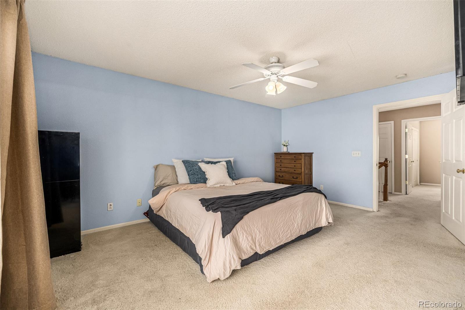 21300 East 42nd Avenue Denver, CO 80249 - Photo 35 of 48 a bedroom with bed and a chandelier