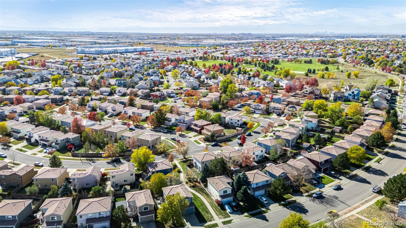 21300 East 42nd Avenue Denver, CO 80249 - Photo 42 of 48 an aerial view of a city with lots of residential buildings and parking space