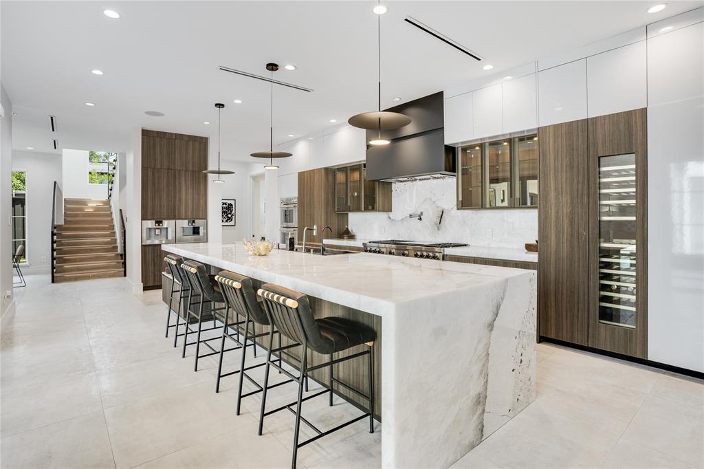 5510 Caladium Drive Dallas, TX 75230 - Photo 13 of 40 a kitchen with stainless steel appliances kitchen island granite countertop a refrigerator and a stove top oven