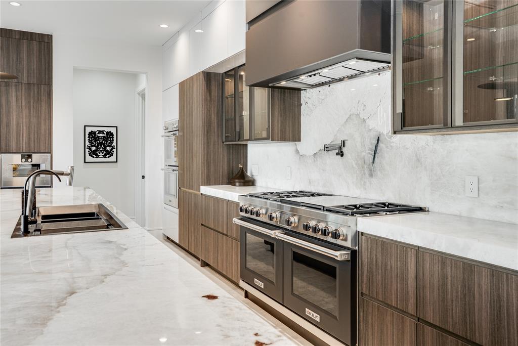 5510 Caladium Drive Dallas, TX 75230 - Photo 14 of 40 a kitchen with granite countertop a stove and a refrigerator