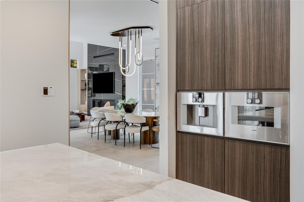 5510 Caladium Drive Dallas, TX 75230 - Photo 15 of 40 a kitchen with stainless steel appliances kitchen island granite countertop a refrigerator and a sink