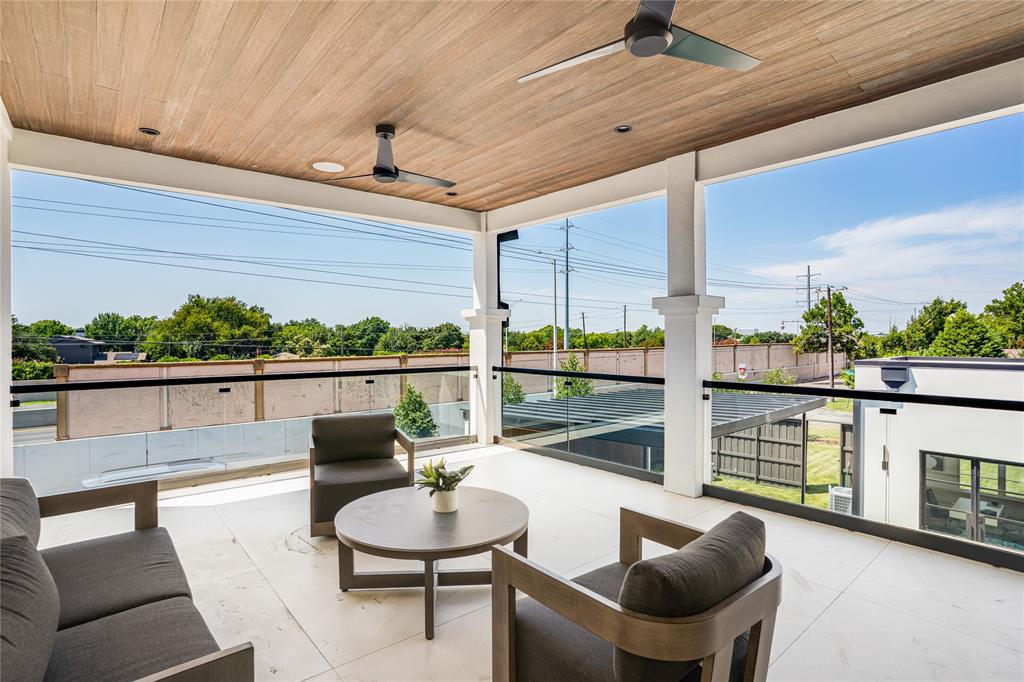 5510 Caladium Drive Dallas, TX 75230 - Photo 25 of 40 a view of a balcony with chairs and a table