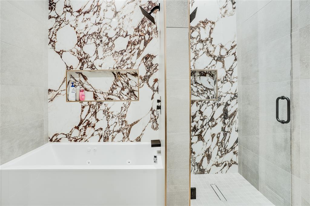 5510 Caladium Drive Dallas, TX 75230 - Photo 29 of 40 a bathroom with a bathtub and shower