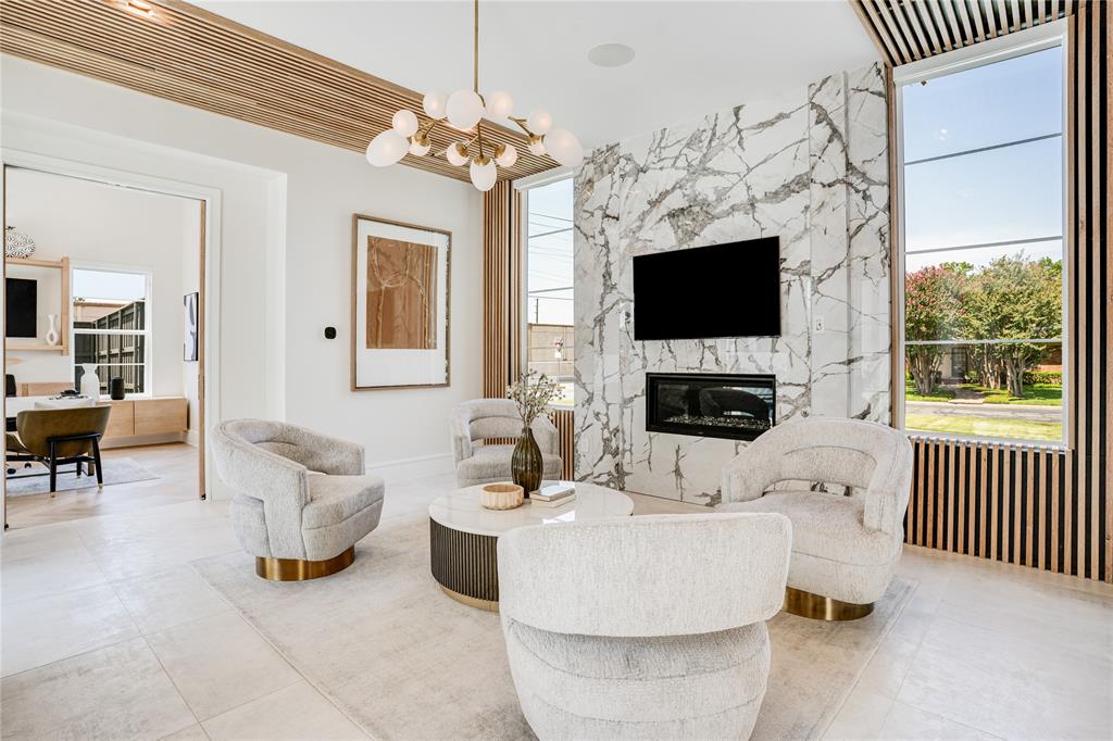 5510 Caladium Drive Dallas, TX 75230 - Photo 4 of 40 a living room with furniture a flat screen tv and a fireplace