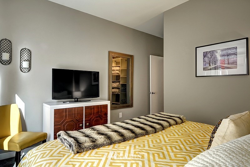 2415 2nd Avenue, Unit 547 Seattle, WA 98121 - Photo 11 of 20 a bedroom with a bed and a flat screen tv