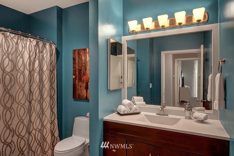 2415 2nd Avenue, Unit 547 Seattle, WA 98121 - Photo 12 of 20 a bathroom with a toilet sink and mirror