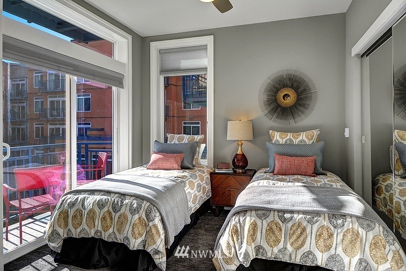 2415 2nd Avenue, Unit 547 Seattle, WA 98121 - Photo 13 of 20 a bedroom with two beds and a large window