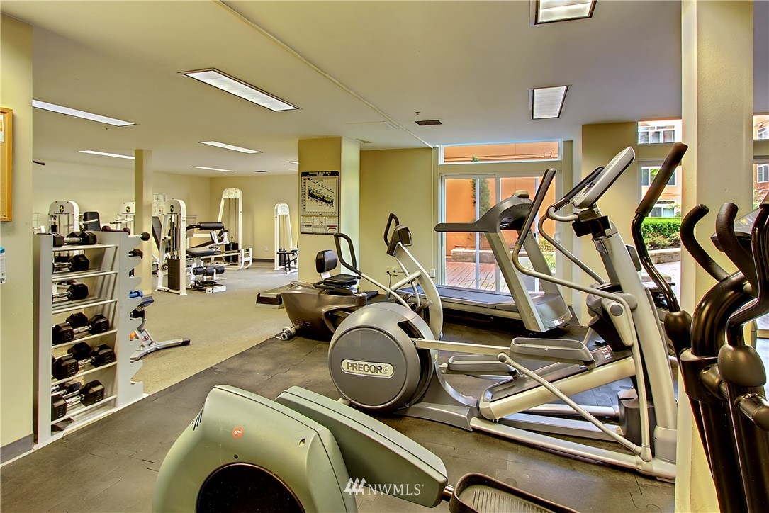 2415 2nd Avenue, Unit 547 Seattle, WA 98121 - Photo 17 of 20 a room with gym equipment and mirror