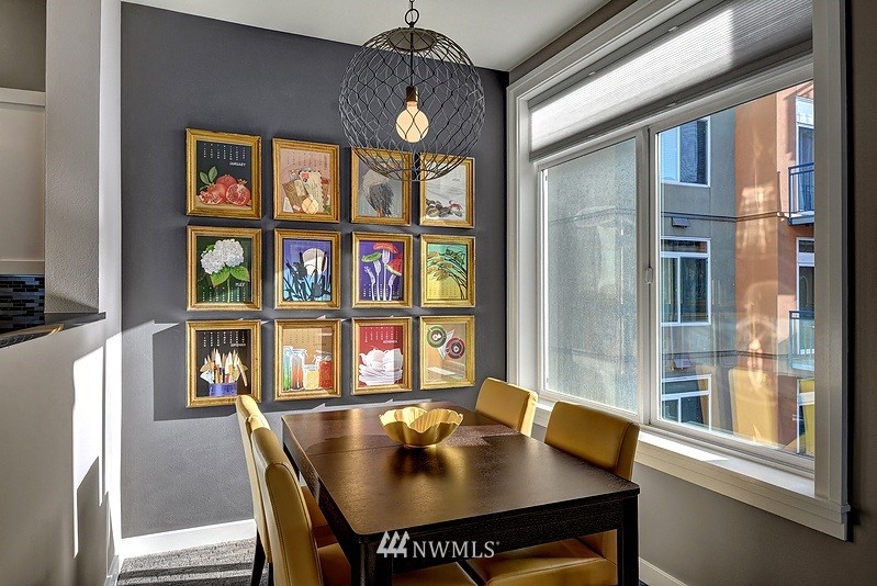 2415 2nd Avenue, Unit 547 Seattle, WA 98121 - Photo 8 of 20 a view of a dining room with furniture window and wooden floor