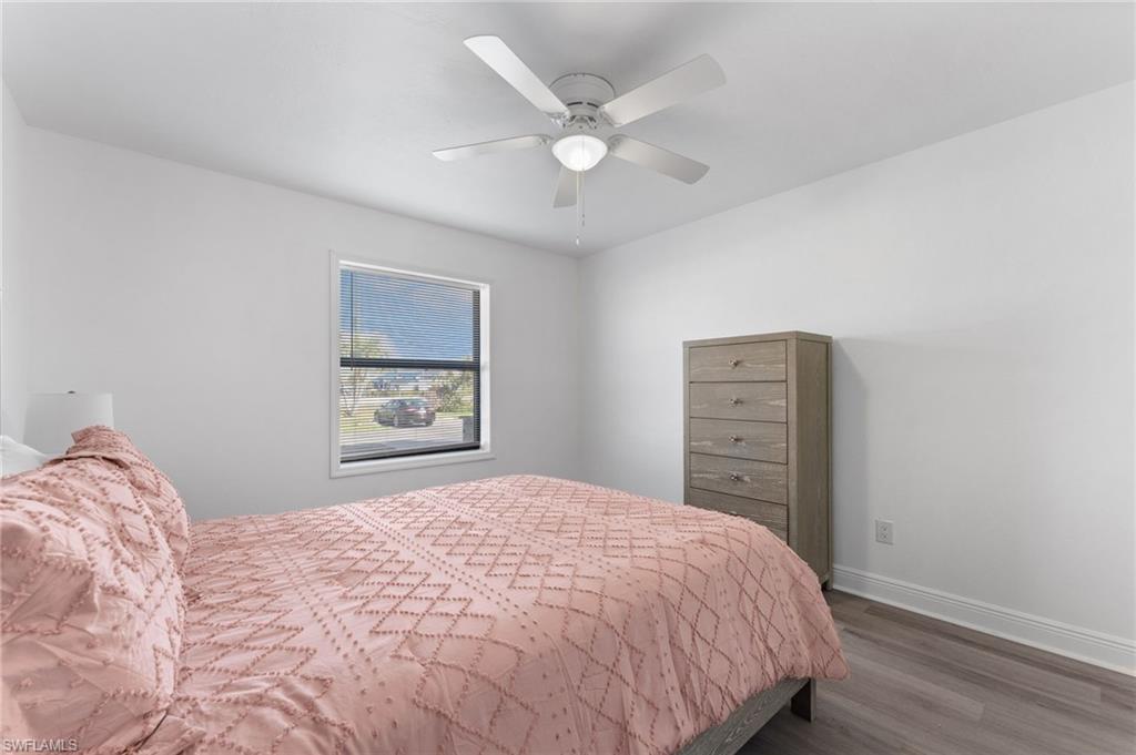 14053 Northumberland Drive Southwest, Unit 105 Fort Myers, FL 33908 - Photo 22 of 38 a bedroom with a bed and a painting on the wall