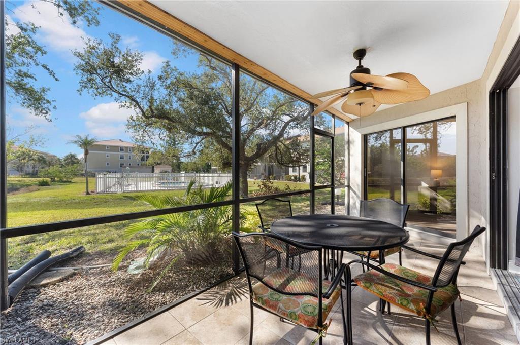 14053 Northumberland Drive Southwest, Unit 105 Fort Myers, FL 33908 - Photo 26 of 38 a view of a patio with a table chairs and a swimming pool