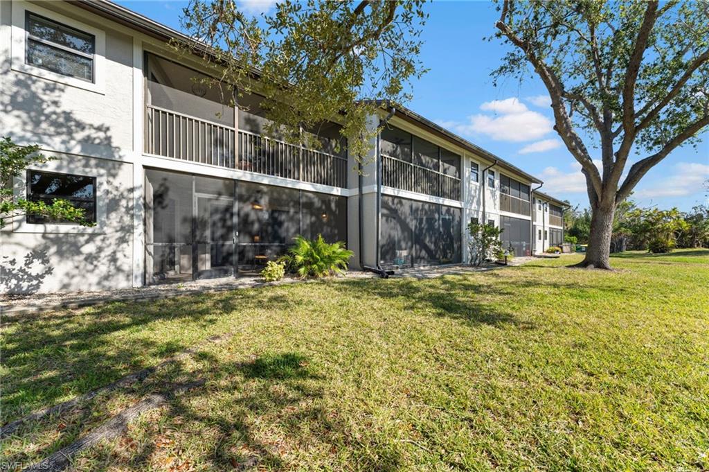 14053 Northumberland Drive Southwest, Unit 105 Fort Myers, FL 33908 - Photo 32 of 38 a view of a house with a yard
