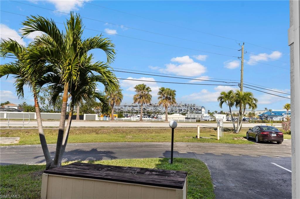 14053 Northumberland Drive Southwest, Unit 105 Fort Myers, FL 33908 - Photo 36 of 38 a view of a swimming pool with a table and chairs