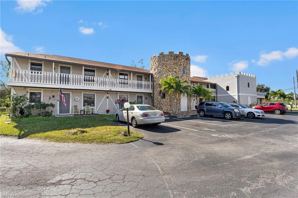 14053 Northumberland Drive Southwest, Unit 105 Fort Myers, FL 33908 - Photo 38 of 38 a view of a building with cars parked in front of house