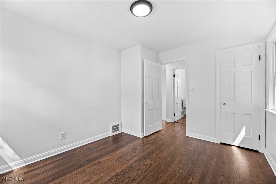 7719 Ackley Road Parma, OH 44129 - Photo 26 of 35 Unfurnished bedroom with baseboards and dark wood-style floors