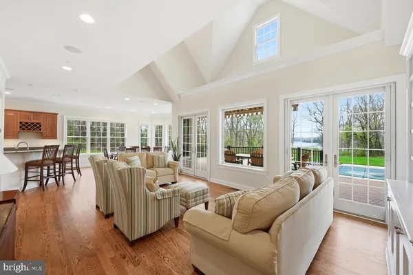 a living room with furniture and a large window with wooden floor