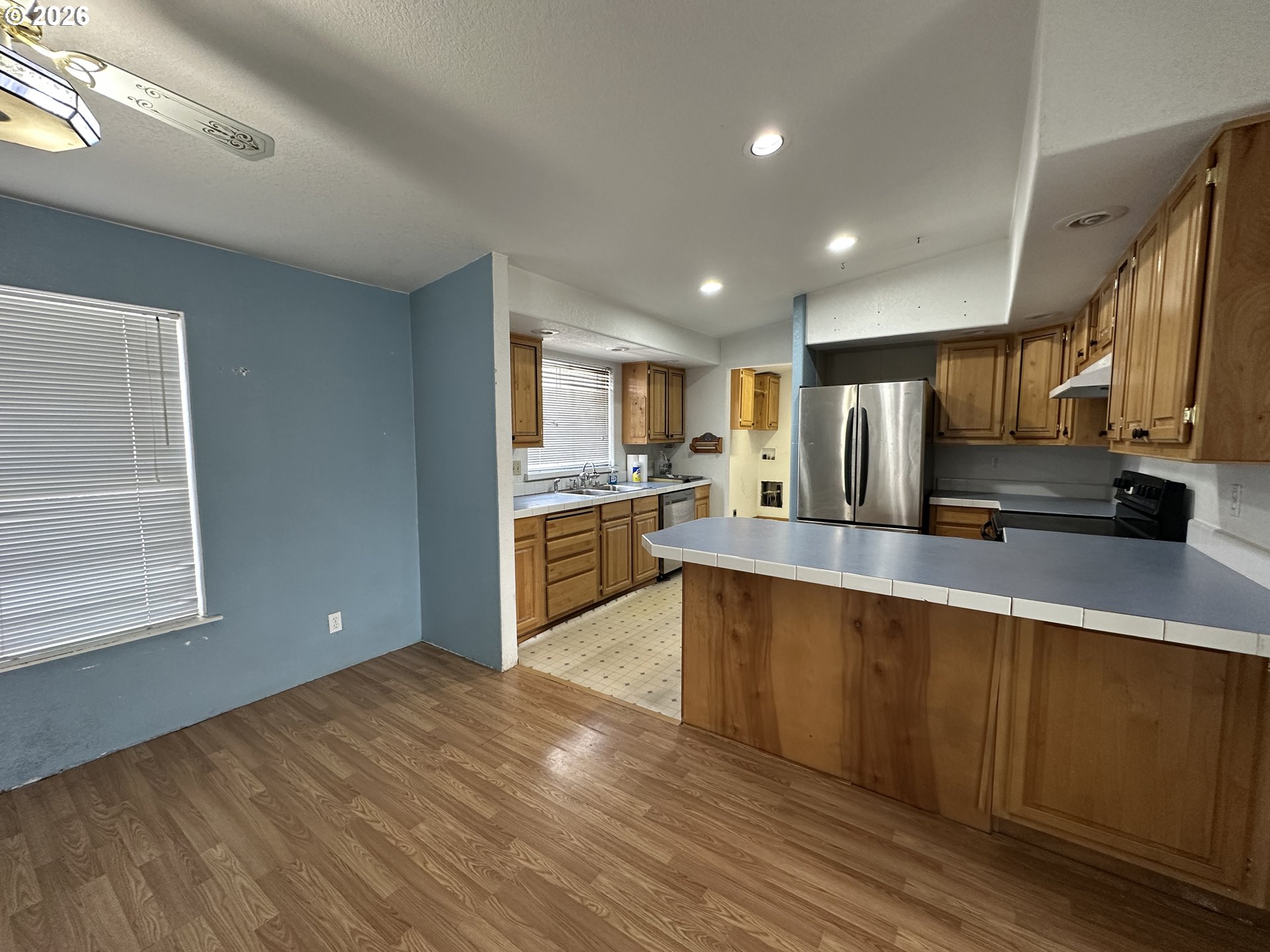404 West 2nd Street Fossil, OR 97830 - Photo 10 of 19 a large kitchen with stainless steel appliances granite countertop a large counter top a sink dishwasher and a refrigerator
