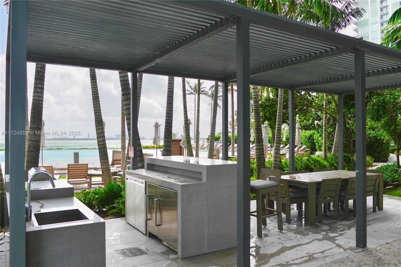 650 Northeast 32nd Street, Unit 2703 Miami, FL 33137 - Photo 24 of 48 a patio with a patio table and chairs