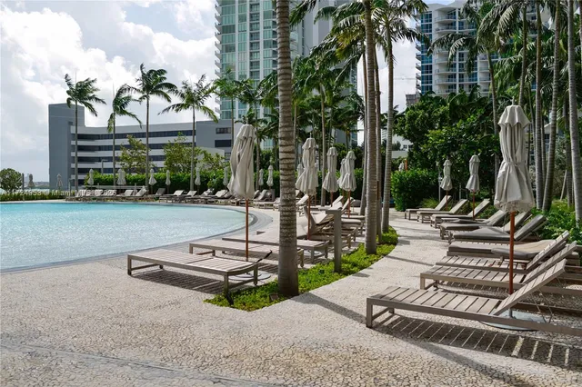 a view of a patio with a table and chairs and potted plants