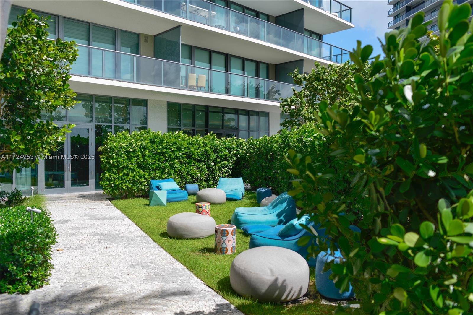650 Northeast 32nd Street, Unit 2703 Miami, FL 33137 - Photo 27 of 48 a view of an chairs and table in the backyard
