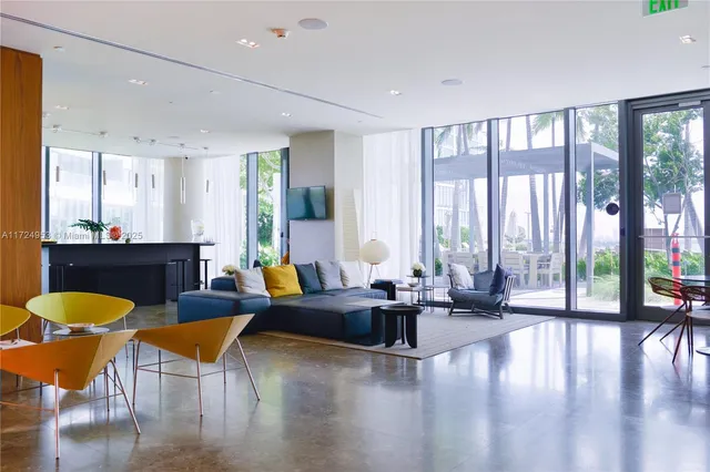 a room with table chairs piano and wooden floor