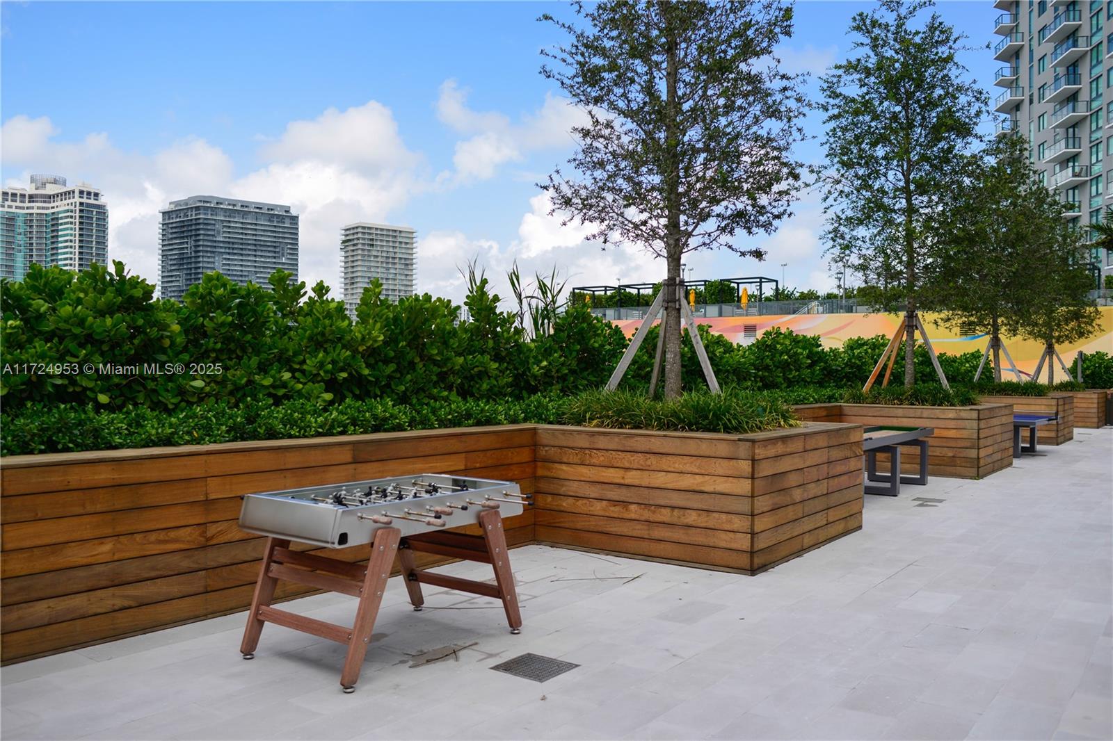 650 Northeast 32nd Street, Unit 2703 Miami, FL 33137 - Photo 40 of 48 a view of outdoor sitting area with furniture and trees