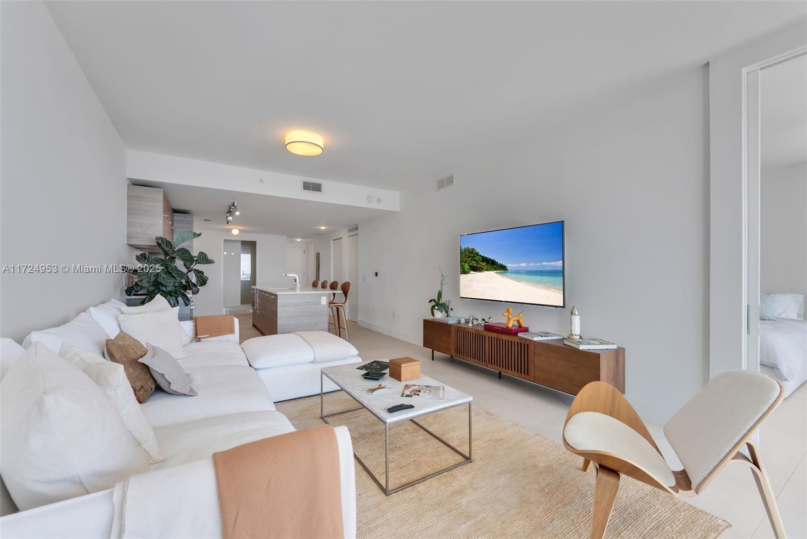 650 Northeast 32nd Street, Unit 2703 Miami, FL 33137 - Photo 7 of 48 a living room with furniture and a flat screen tv