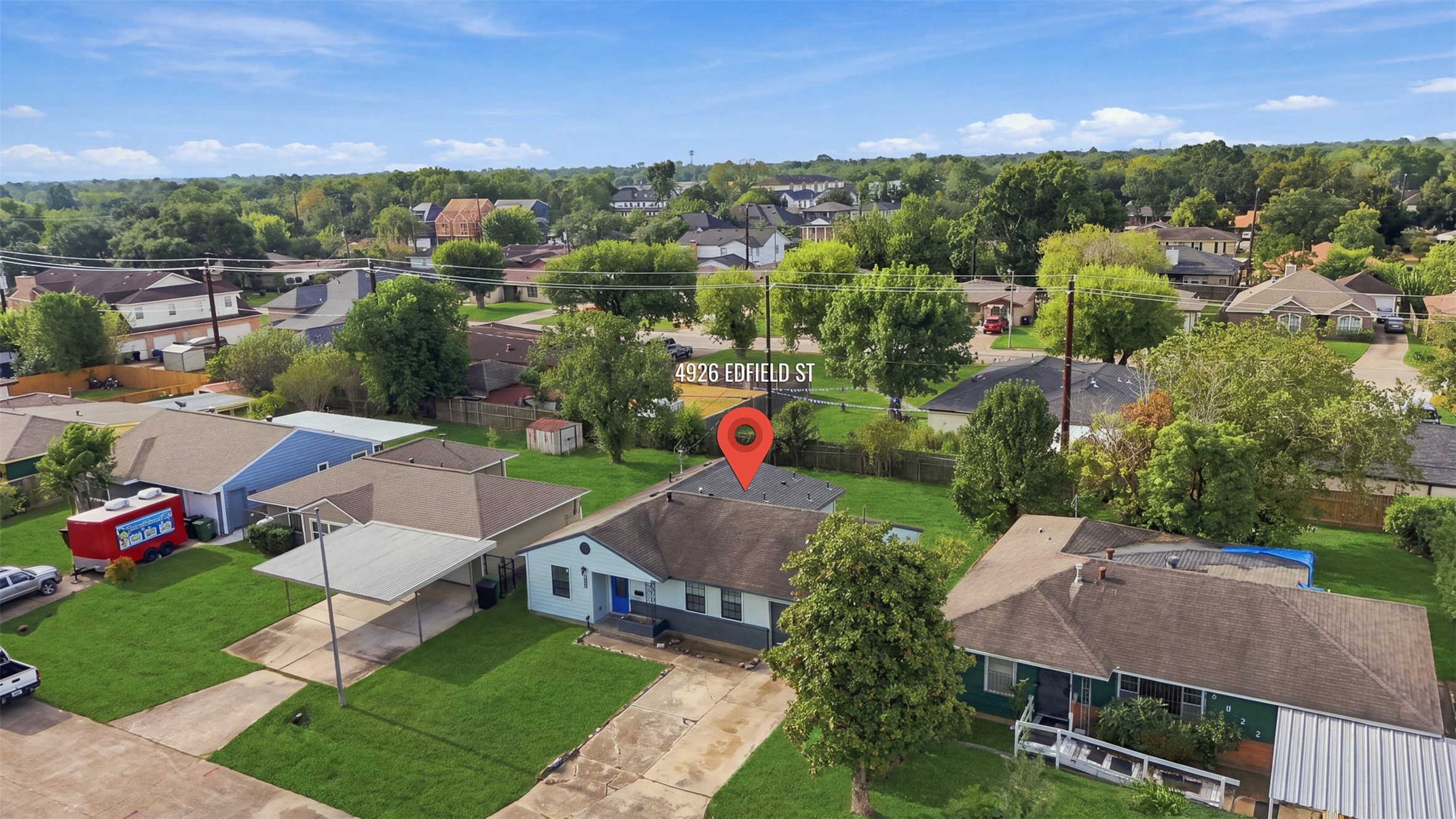 4926 Edfield Street Houston, TX 77033 - Photo 23 of 30 Charming single-story home with a spacious front yard and covered parking, set in a serene neighborhood with lush greenery and well-maintained surroundings.