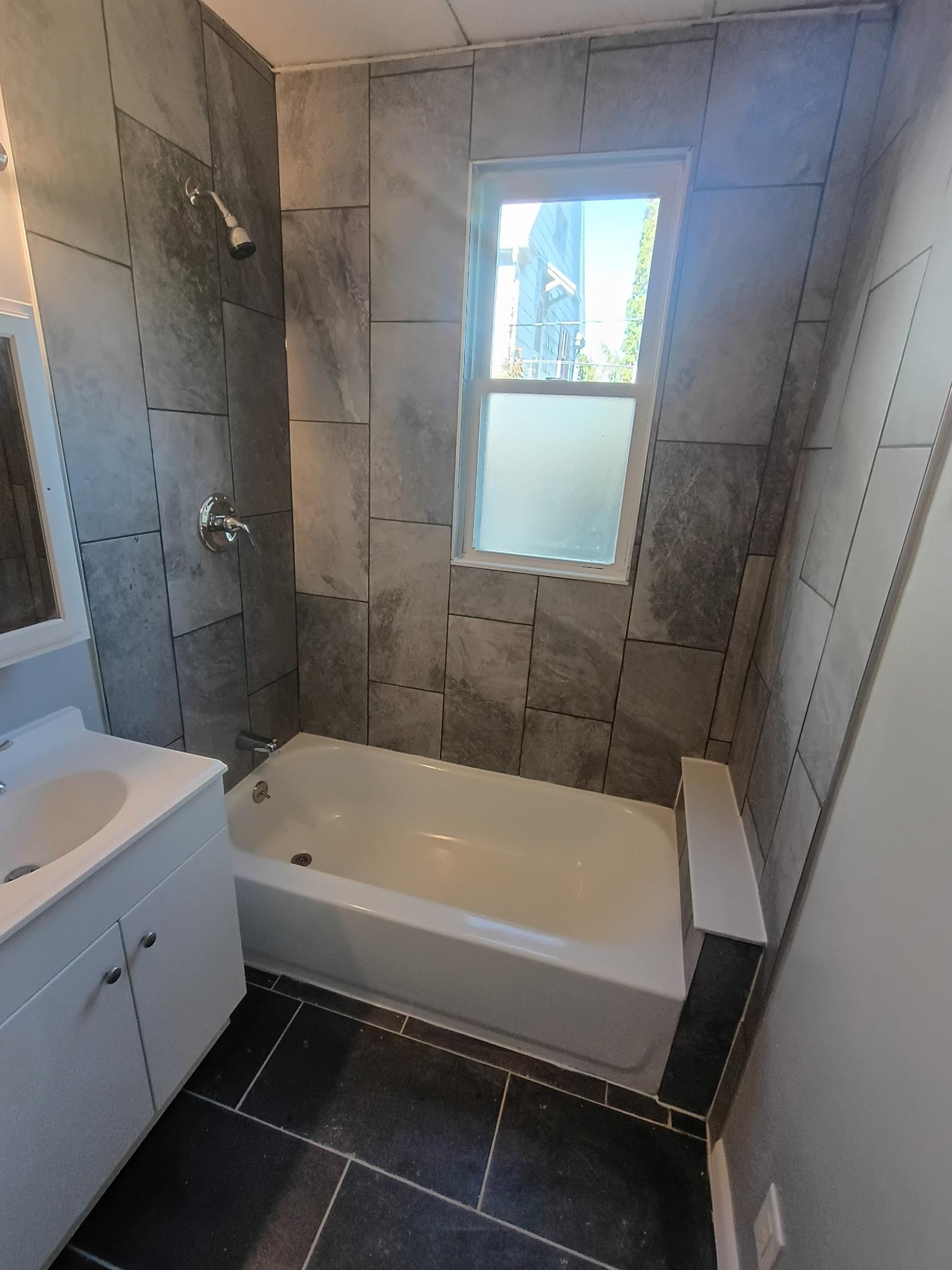 124 South Prospect Street Rockford, IL 61104 - Photo 11 of 13 a bathroom with a sink a bathtub and window