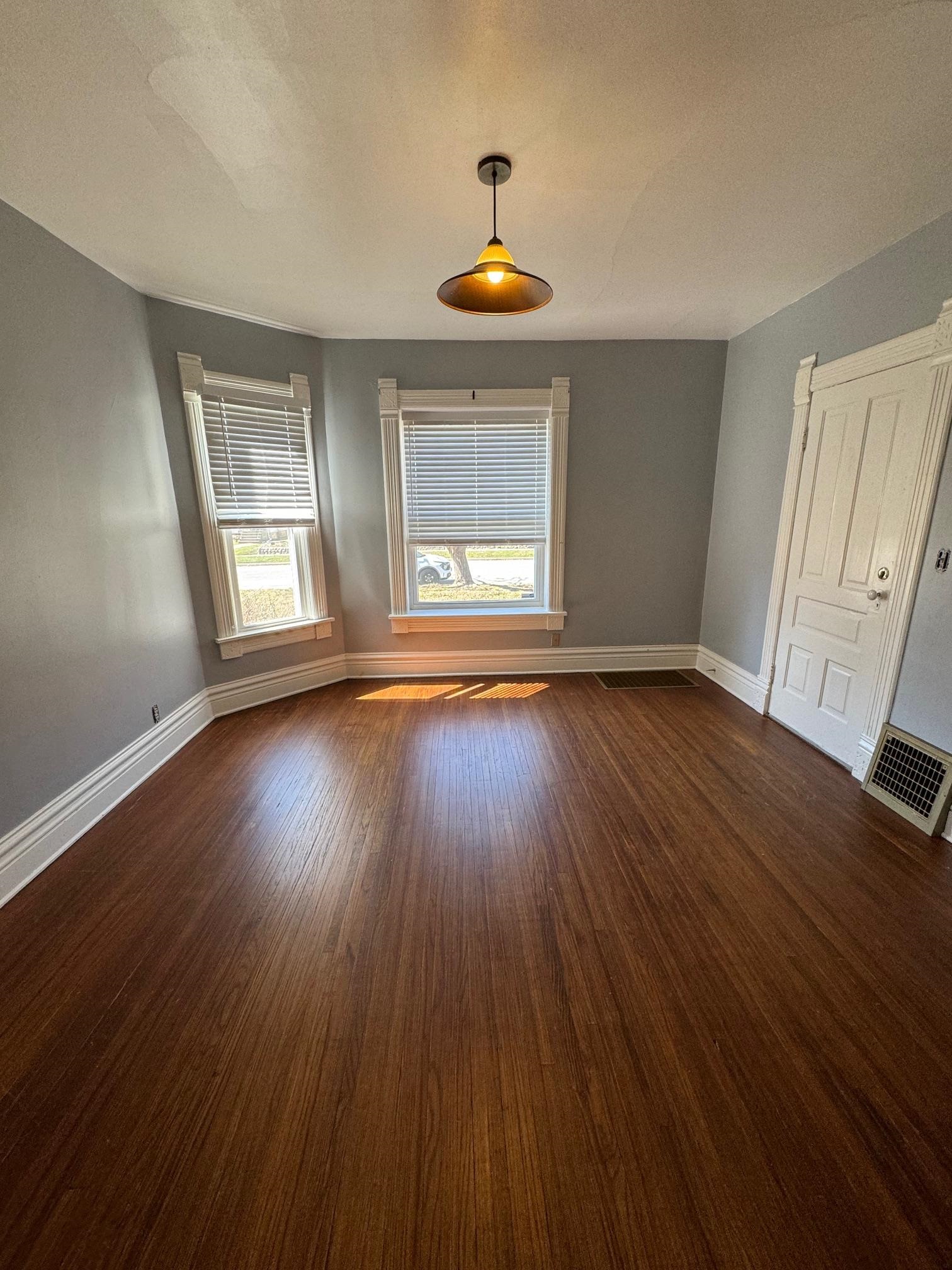 124 South Prospect Street Rockford, IL 61104 - Photo 4 of 13 a view of an empty room with wooden floor and a window