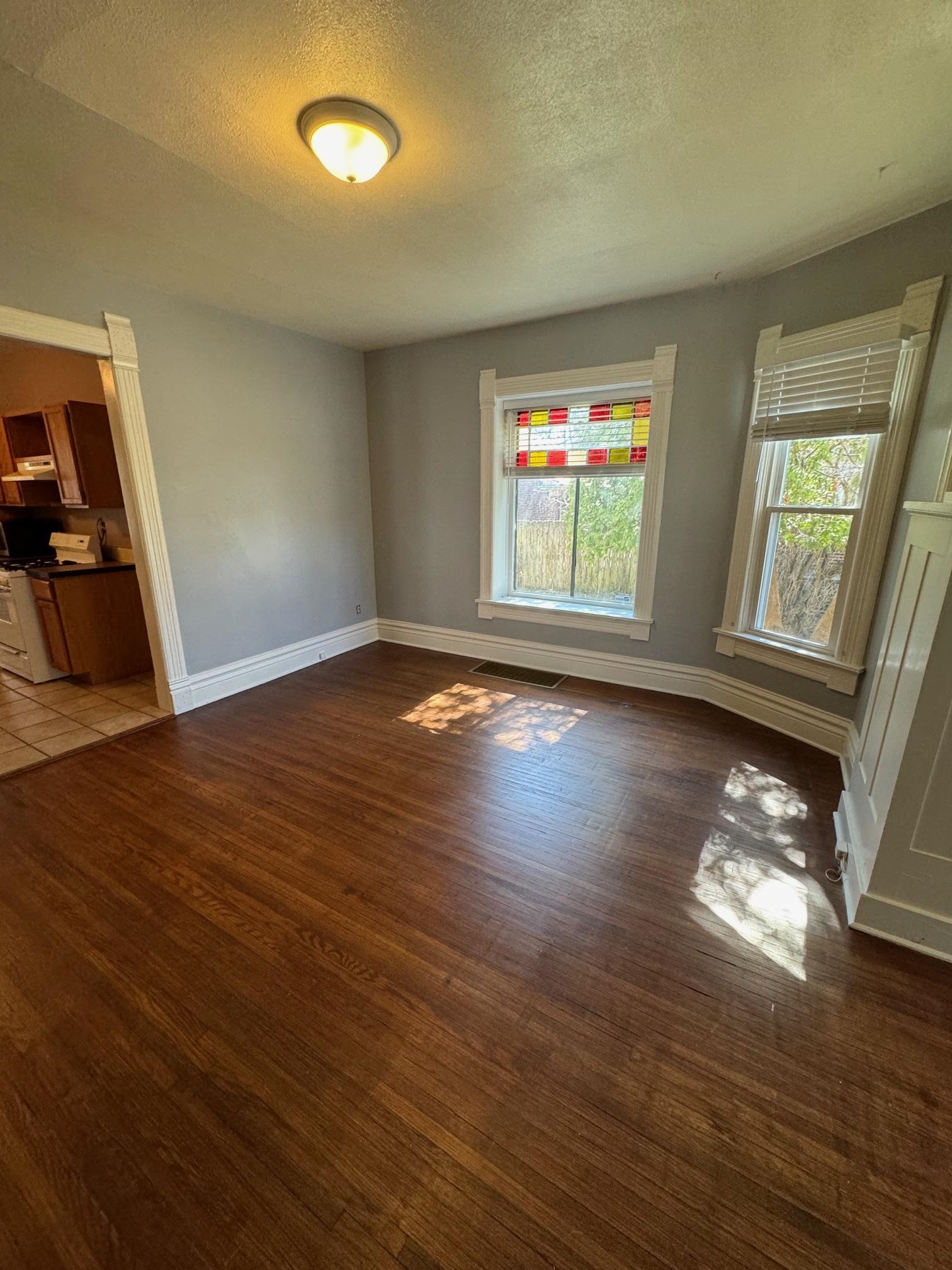 124 South Prospect Street Rockford, IL 61104 - Photo 5 of 13 an empty room with wooden floor and windows