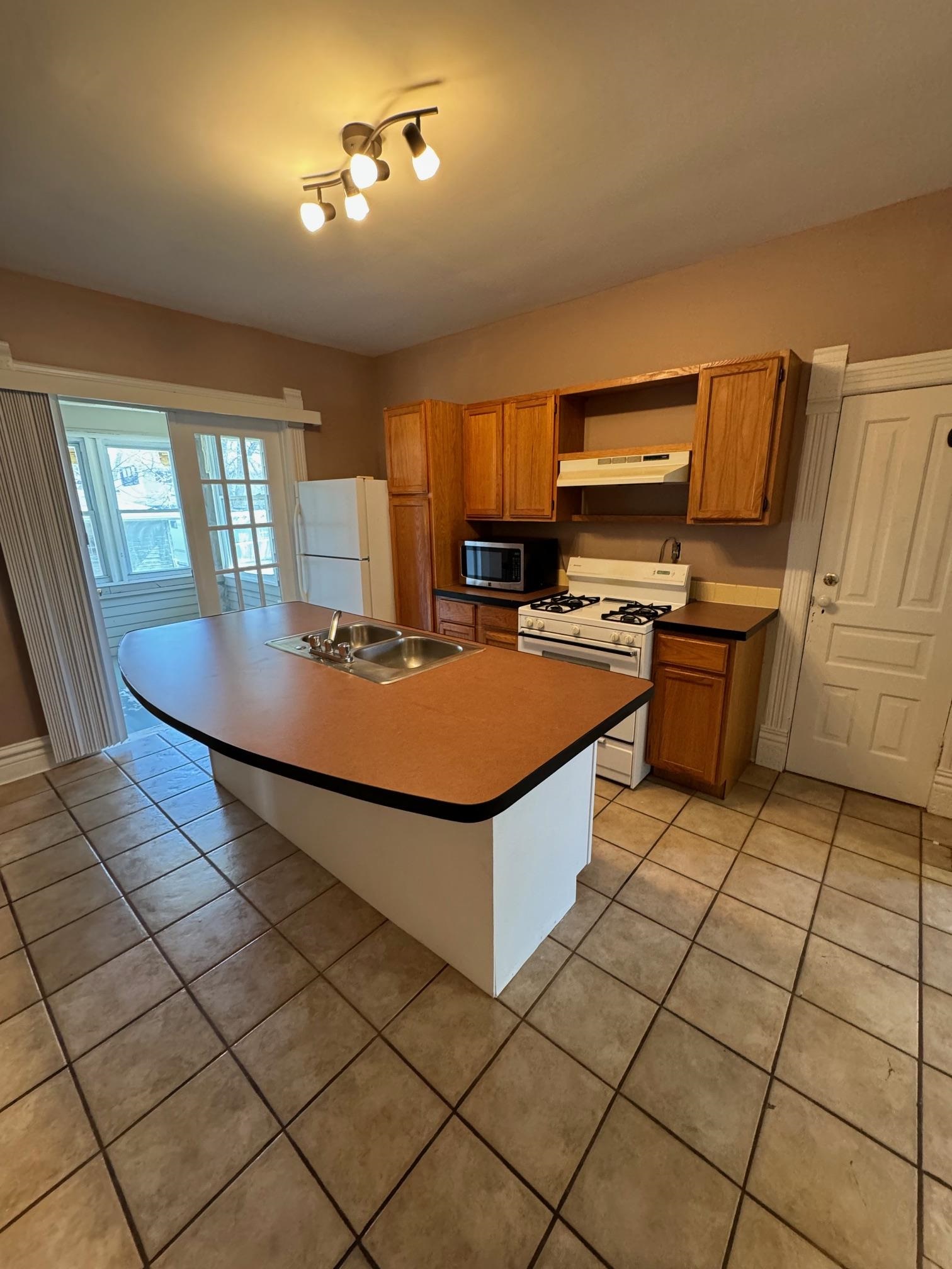 124 South Prospect Street Rockford, IL 61104 - Photo 8 of 13 a kitchen with stainless steel appliances granite countertop a stove top oven a sink dishwasher and a refrigerator