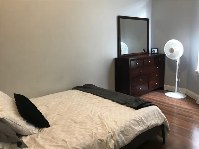 a bedroom with a bed and a mirror