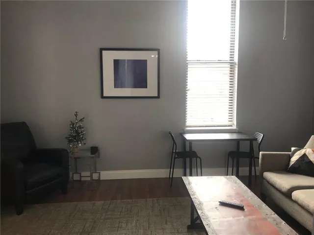 a view of a livingroom with furniture and a window