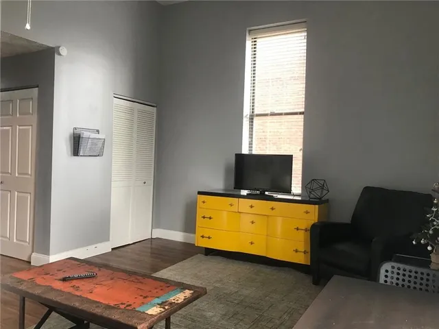 a living room with furniture and flat screen tv