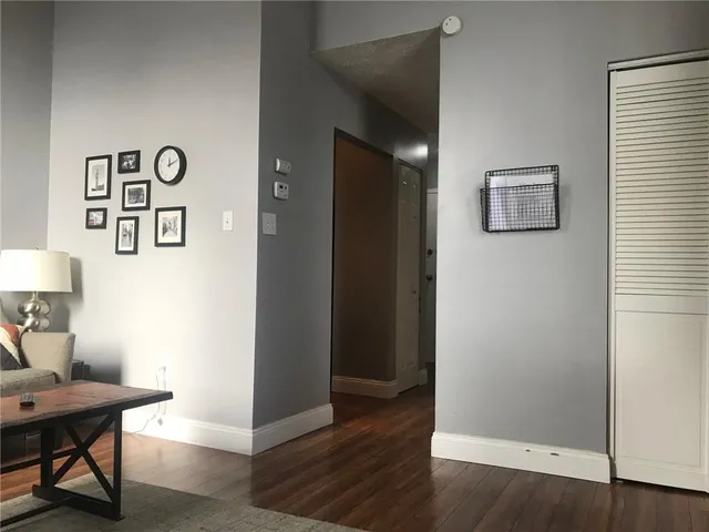 a view of a workspace room with wooden floor and cabinet