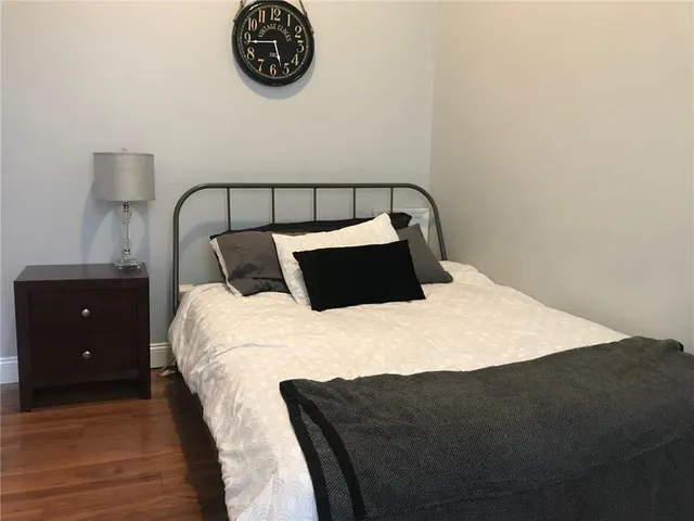 a bedroom with a bed and a night stand