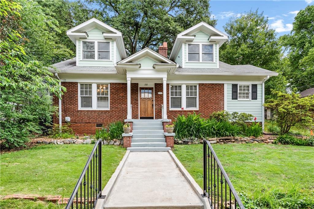 252 Kings Highway Decatur, GA 30030 - Photo 1 of 1 a front view of a house with a yard and potted plants