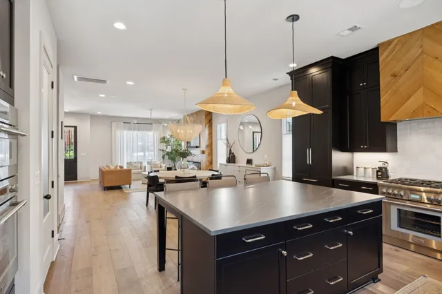 an open kitchen with dining table and a chandelier