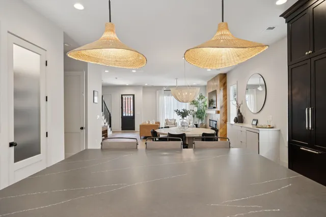 a large kitchen with stainless steel appliances granite countertop a lot of counter space and a sink