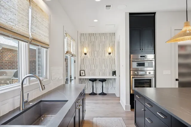 a kitchen with stainless steel appliances a refrigerator and a stove