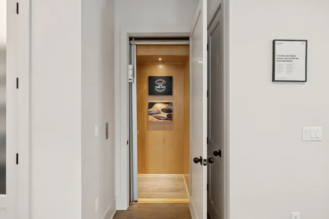 a view of staircase with wooden floor and white walls