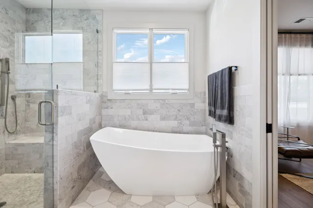 a bathroom with a bathtub and shower
