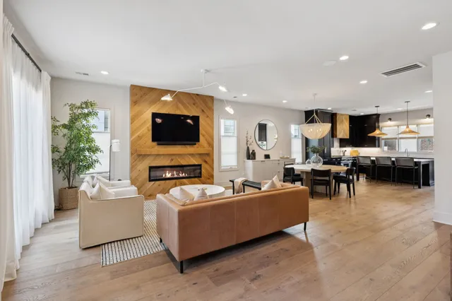 a living room with fireplace furniture and a flat screen tv