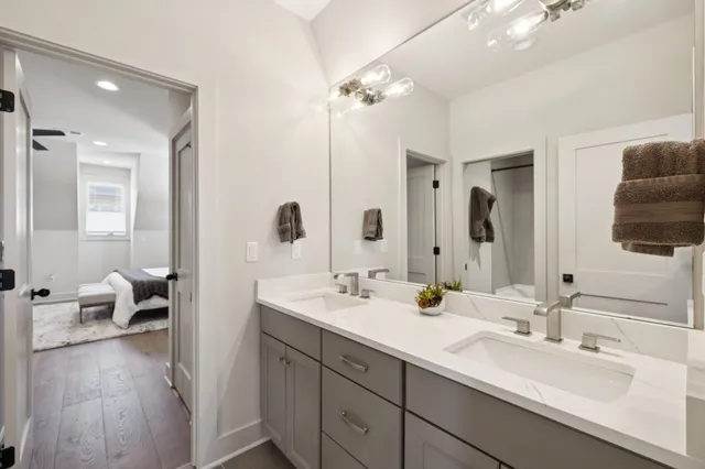 a bedroom with a bed and a large mirror