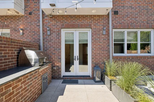 a front view of a house with outdoor seating