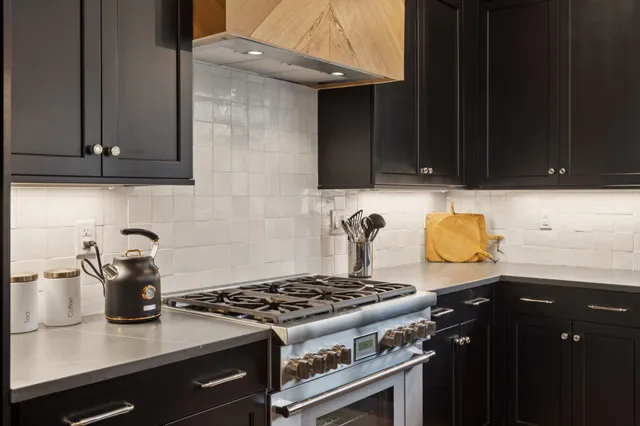 a kitchen with granite countertop a stove and a cabinets